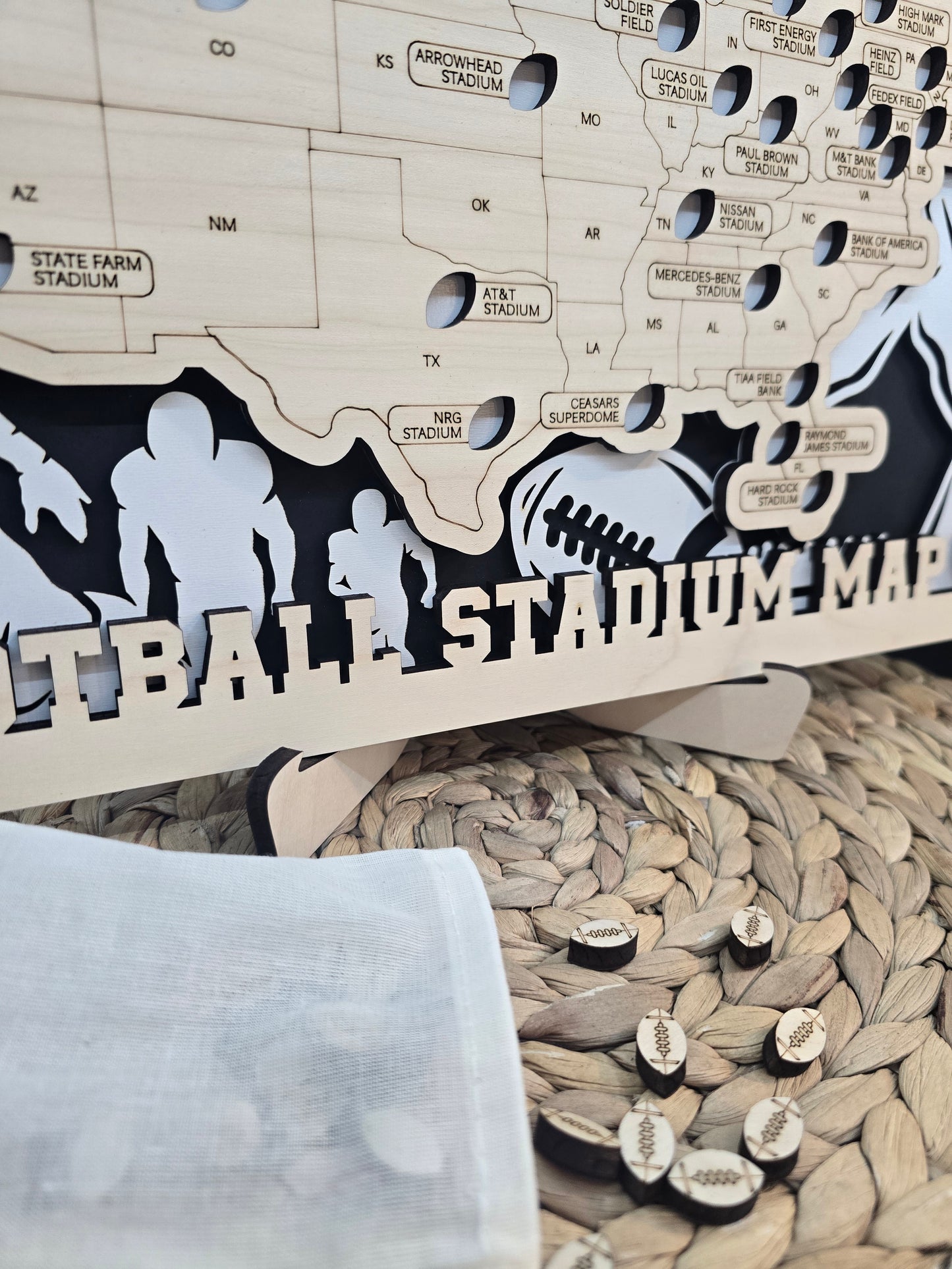 Stadium Series Football Map with wooden football-shaped stadium markers scattered on a woven surface, ready to be placed on the map