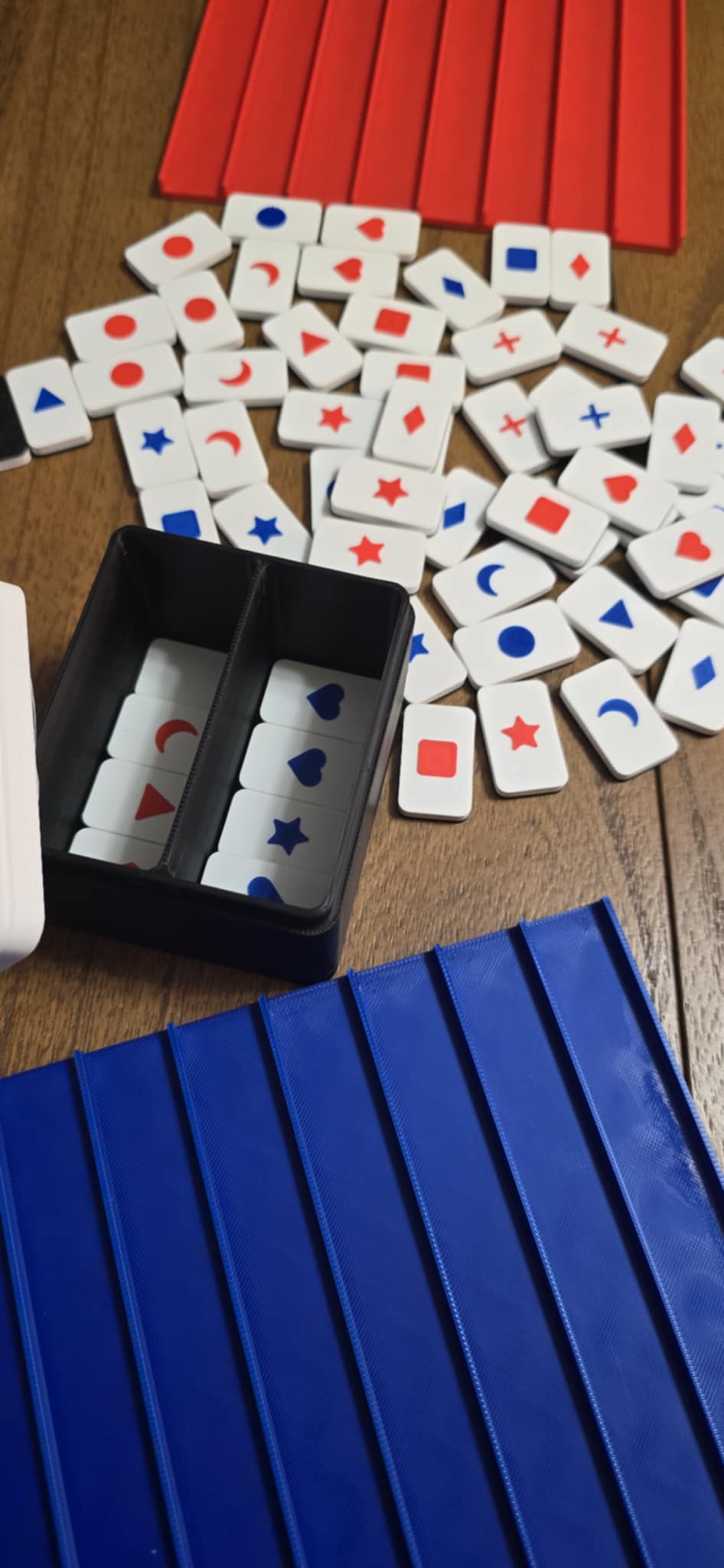 Red and blue push tile game set with two player boards