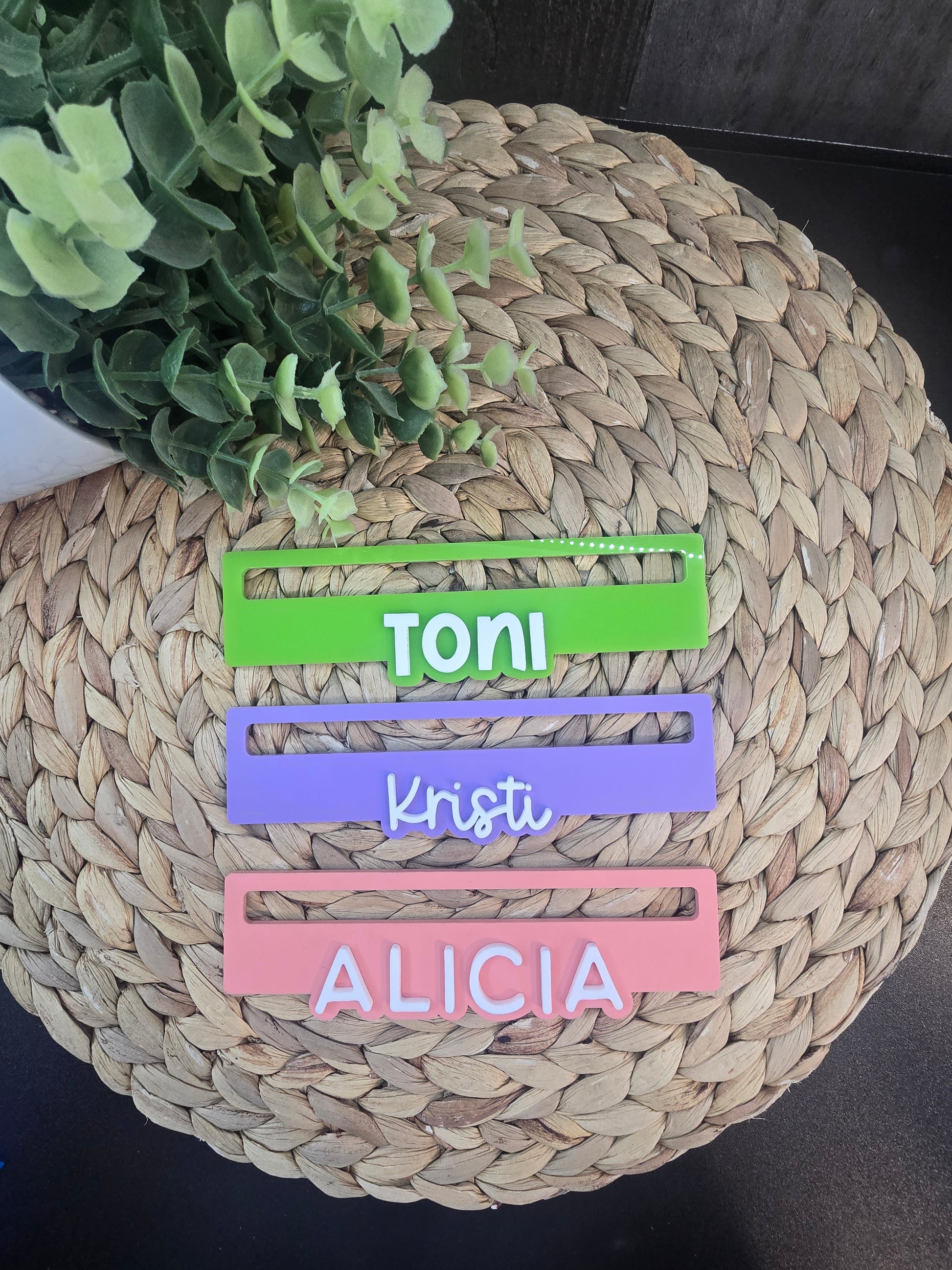 Three personalized Mahjong line readers in green, purple, and pink acrylic, custom engraved with the names Toni, Kristi, and Alicia